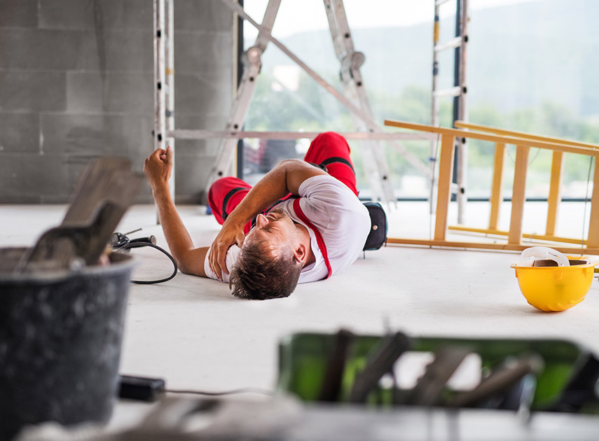 Male-construction-worker-lying-on-the-floor-in-pain-after-fall