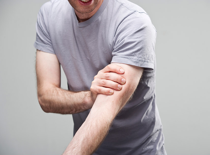 Man-experiencing-pain-in-the-arm,-a-symptom-of-reflex-sympathetic-dystrophy